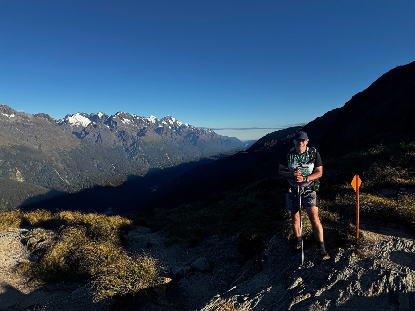 Mike on the Routeburn Track with mountain views behind him